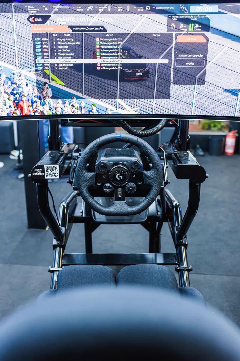 Driving simulator cockpit with steering wheel and racing screen