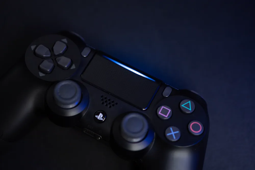 PlayStation 4 controller lit by blue light